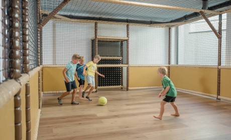 Children playing indoor football in the FUN ARENA